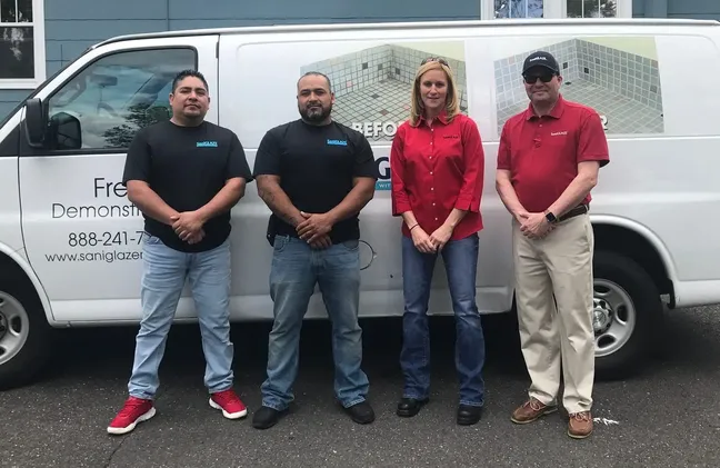 Tile Restoration employees standing by a work van